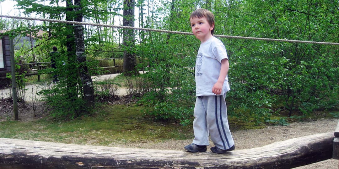Boy balancing on a log