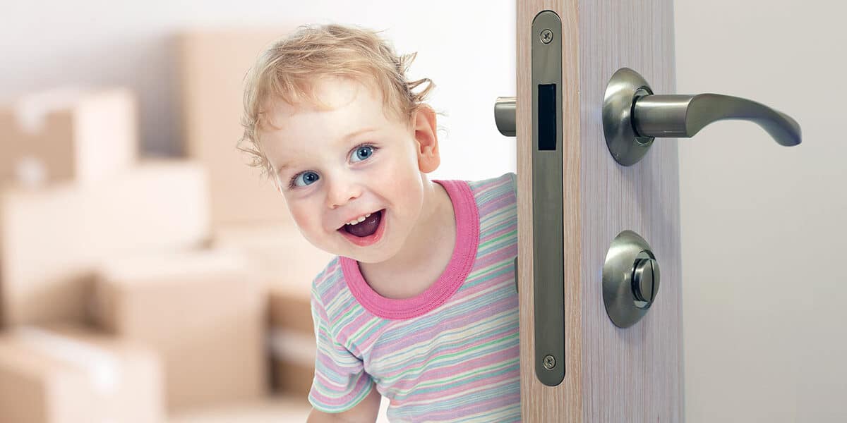 Happy child opening lever door