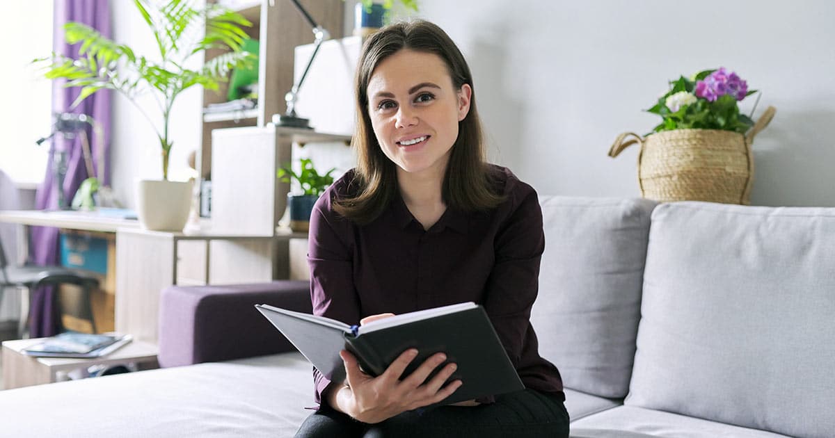 Woman with book in beautiful consulting room